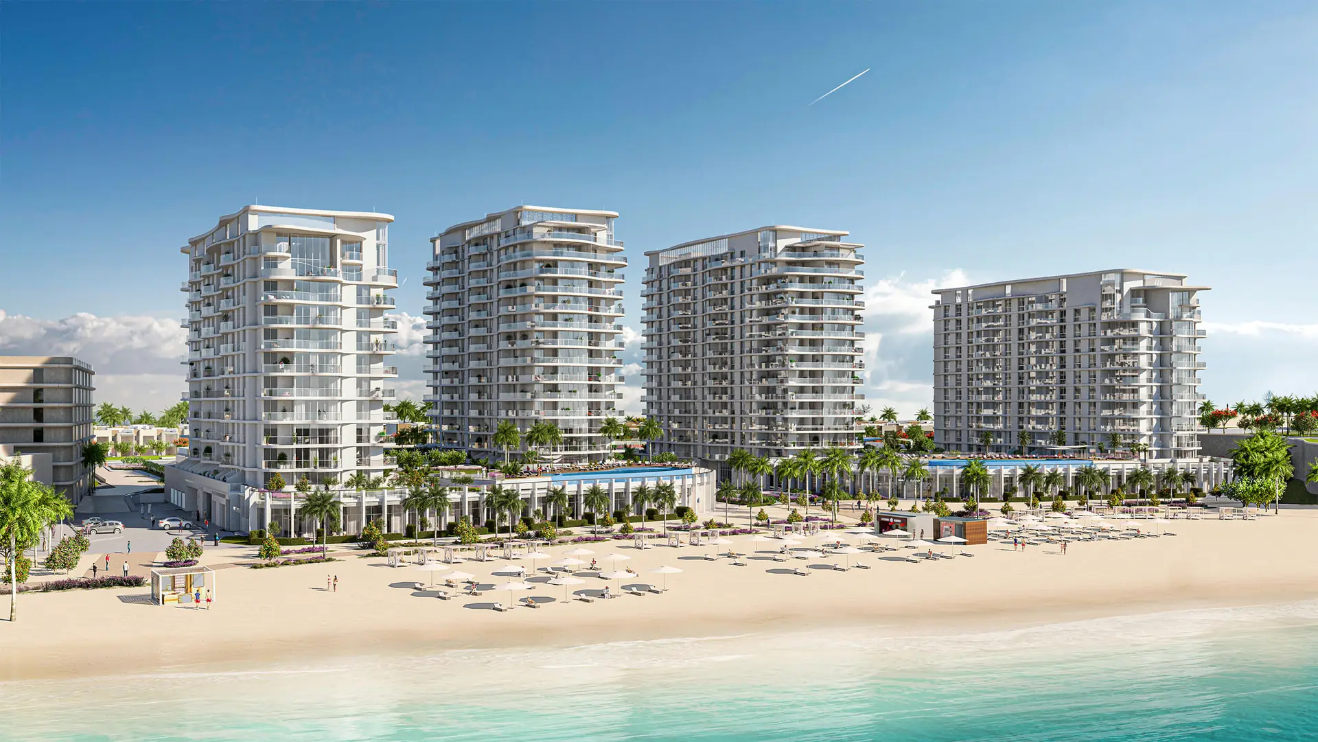 Beach House – four residential towers behind a sandy beach with sun loungers and turquoise sea
