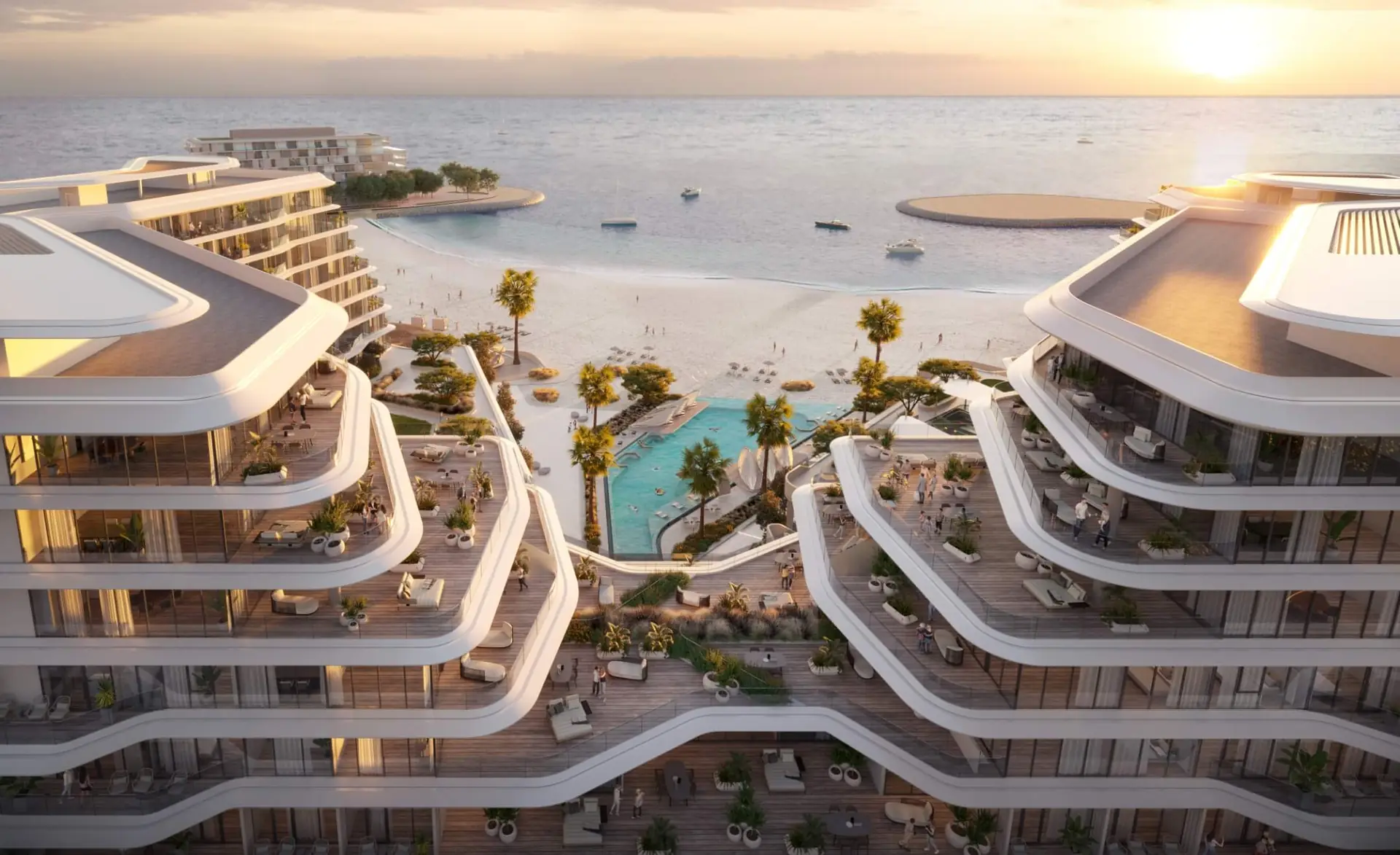 Porto Playa – aerial view of curved terraced buildings around a pool, beach and sea at sunset