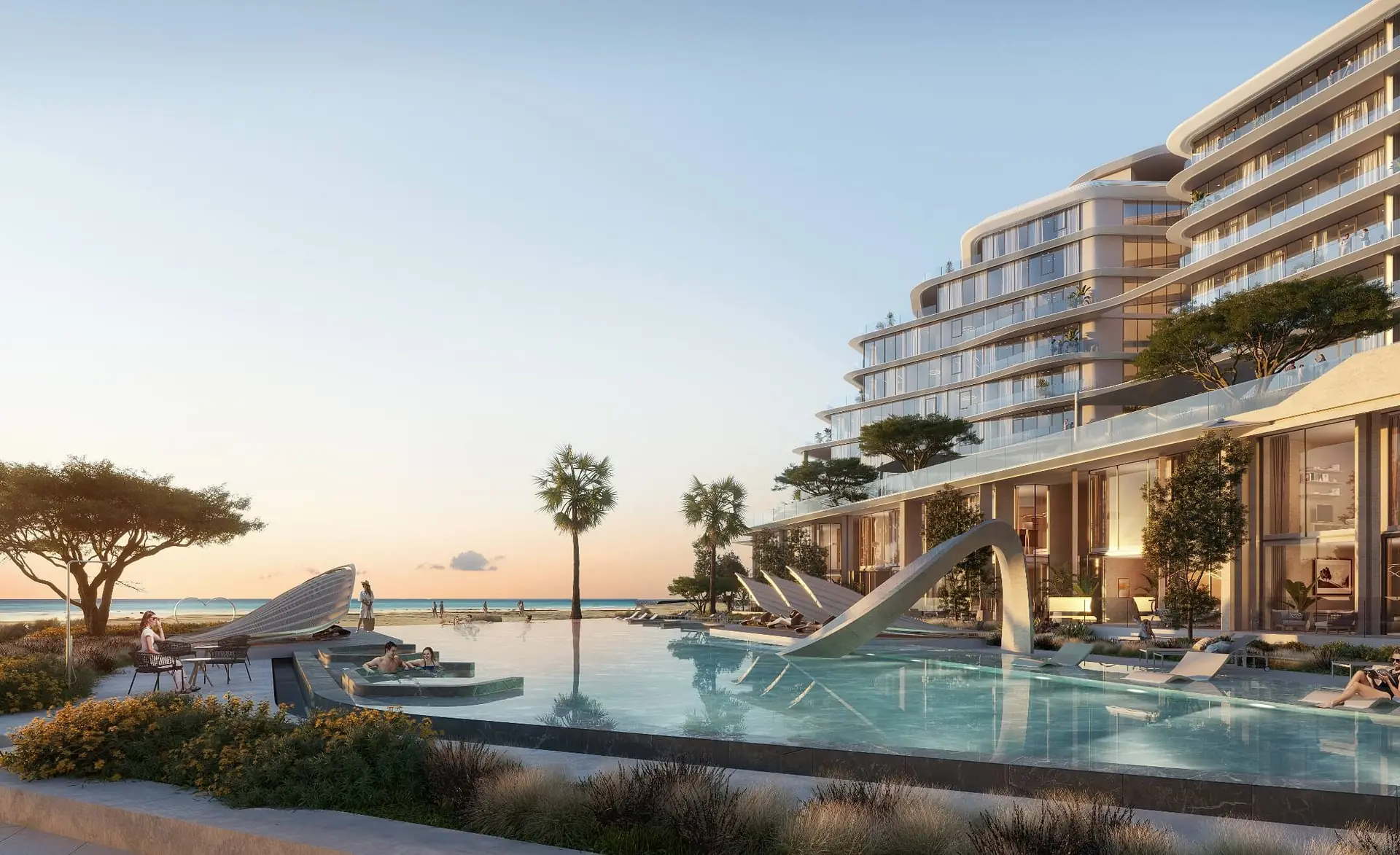 Porto Playa – infinity pool with loungers beside the building and the sea at dusk