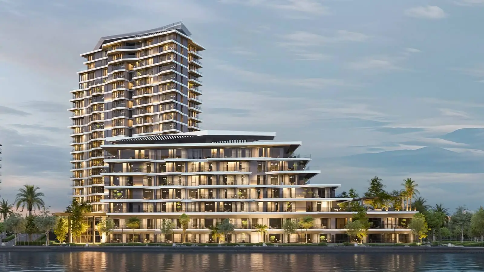 SKAI – stepped residential tower beside the water at dusk